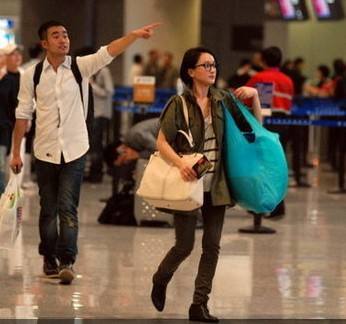 f183ec076a3be1e1571f40fa413bda7c.jpg 左肩背無紡布袋,右肩帆布袋的周迅就這樣出現(xiàn)的機場,果然愧是環(huán)保大使